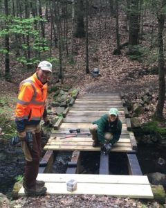 photo of crew members replacing decking on a boardwalk