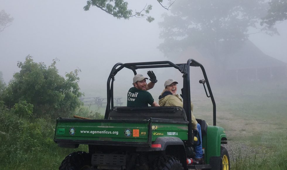 Photo: two people waving from inside 4-wheel at Mount Agamenticus summit in the fog.